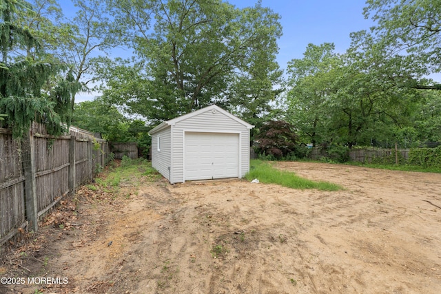 53 Burnt Tavern Rd, Brick, NJ 08724 - detached garage with dirt driveway and view of scattered trees
