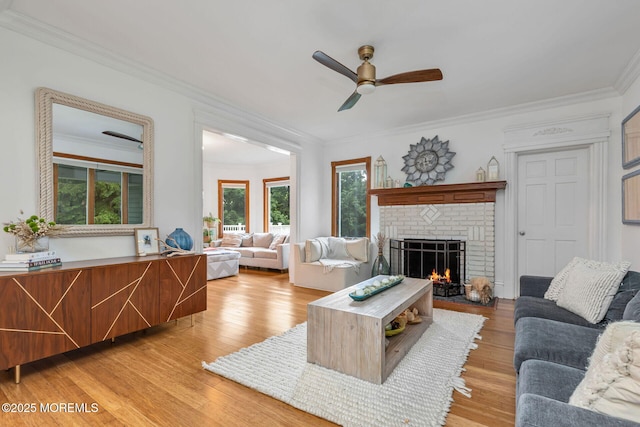 29 Grand Ave, Atlantic Highlands, NJ 07716 - living area with ornamental molding, a fireplace, a ceiling fan, and light wood-style floors