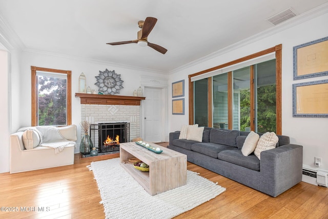 29 Grand Ave, Atlantic Highlands, NJ 07716 - living room with light wood-type flooring, crown molding, a fireplace, a ceiling fan, and a baseboard radiator