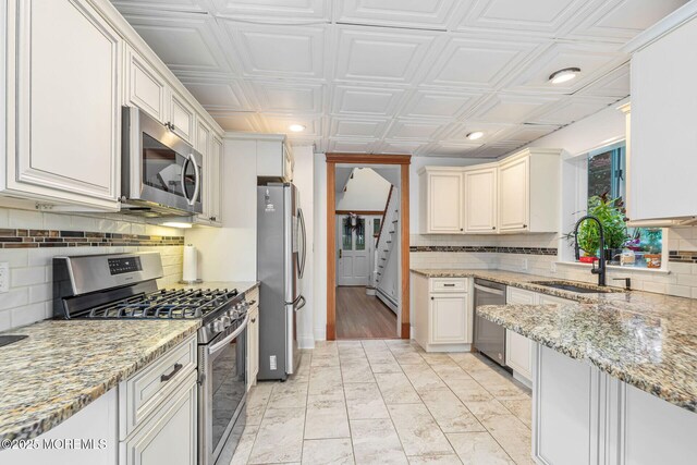 29 Grand Ave, Atlantic Highlands, NJ 07716 - kitchen with stainless steel appliances, a sink, decorative backsplash, recessed lighting, and light stone counters