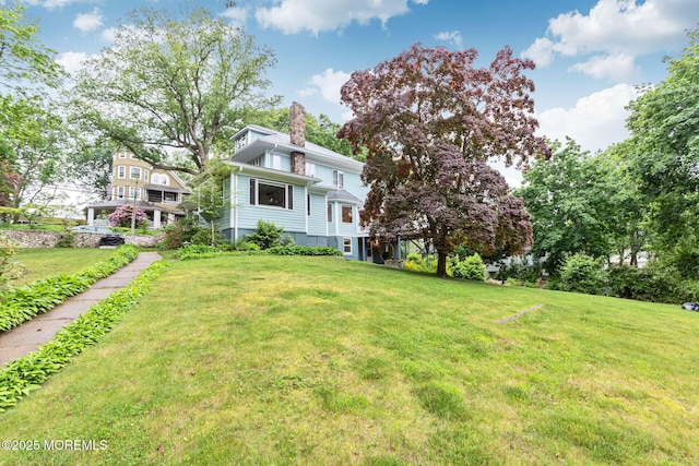 29 Grand Ave, Atlantic Highlands, NJ 07716 - view of front facade with a chimney and a front lawn