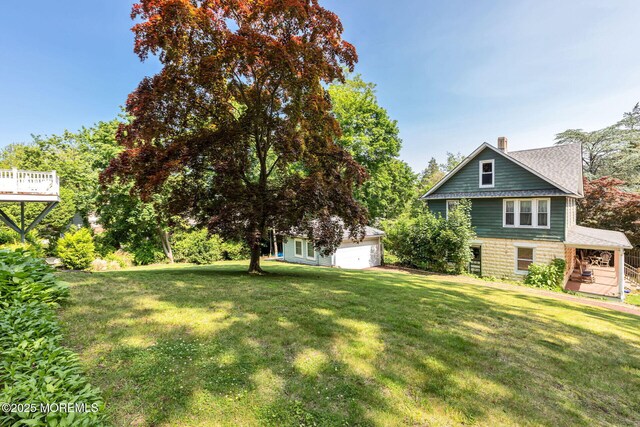 29 Grand Ave, Atlantic Highlands, NJ 07716 - view of green lawn with an outbuilding and a garage
