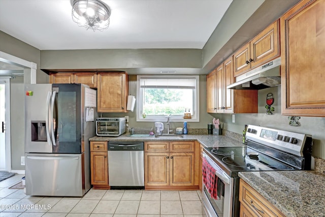 15 Transom Ln, Barnegat, NJ 08005 - kitchen with stainless steel appliances, under cabinet range hood, light tile patterned floors, and brown cabinets