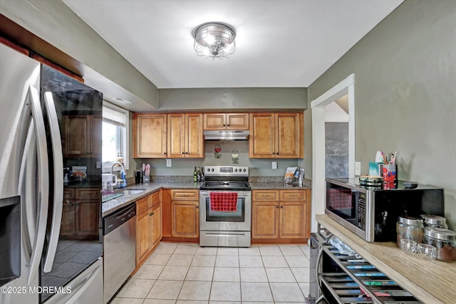 15 Transom Ln, Barnegat, NJ 08005 - kitchen featuring stainless steel appliances, under cabinet range hood, a sink, light tile patterned floors, and stone counters