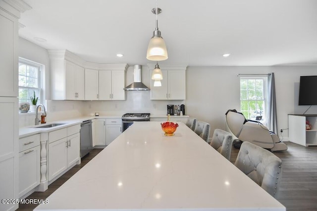 257 Port Monmouth Rd, North Middletown, NJ 07748 - kitchen with wall chimney exhaust hood, stainless steel appliances, a center island, white cabinetry, and tasteful backsplash