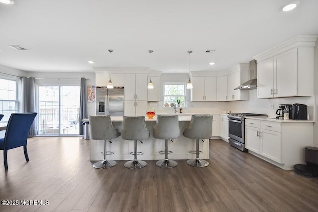 257 Port Monmouth Rd, North Middletown, NJ 07748 - kitchen featuring stainless steel appliances, wall chimney exhaust hood, dark wood-style flooring, recessed lighting, and a kitchen island