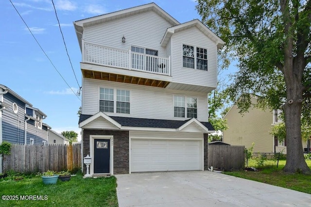 257 Port Monmouth Rd, North Middletown, NJ 07748 - view of front facade featuring a balcony, concrete driveway, a garage, and stone siding