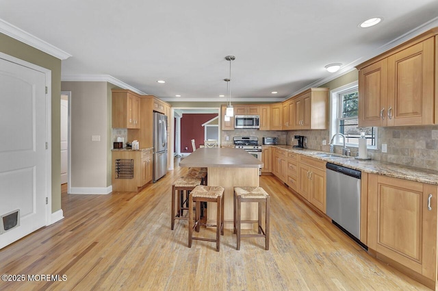 531 Parker Ave, Brick, NJ 08724 - kitchen with stainless steel appliances, a sink, ornamental molding, a breakfast bar area, and tasteful backsplash