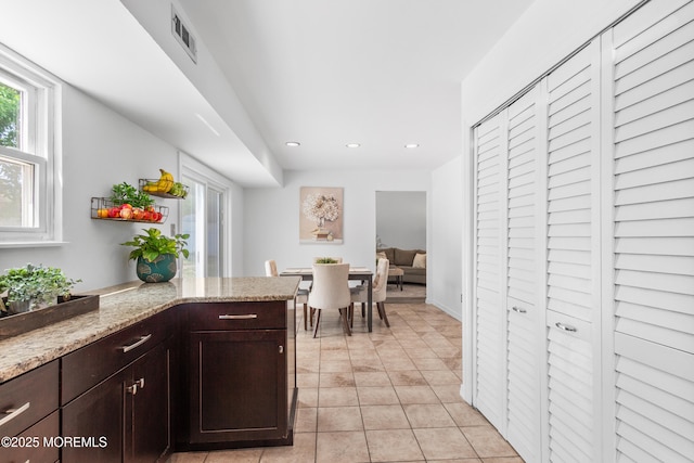 10 Barre Dr, Howell, NJ 07731 - kitchen with recessed lighting, dark brown cabinetry, light tile patterned flooring, and light stone counters