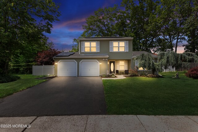 10 Barre Dr, Howell, NJ 07731 - view of front of home with asphalt driveway, roof mounted solar panels, and a garage