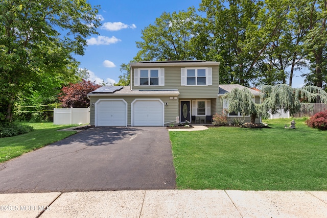 10 Barre Dr, Howell, NJ 07731 - view of front of home featuring asphalt driveway, solar panels, and a garage