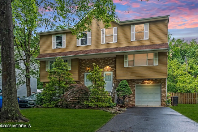 20 Lone Star Ln, Manalapan, NJ 07726 - view of front of home with driveway, a garage, and brick siding