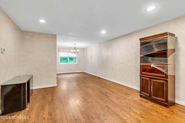 20 Lone Star Ln, Manalapan, NJ 07726 - unfurnished living room with a chandelier, wood finished floors, recessed lighting, and baseboards