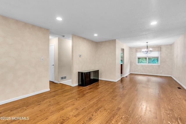 20 Lone Star Ln, Manalapan, NJ 07726 - unfurnished living room with wood finished floors, a chandelier, baseboards, and recessed lighting