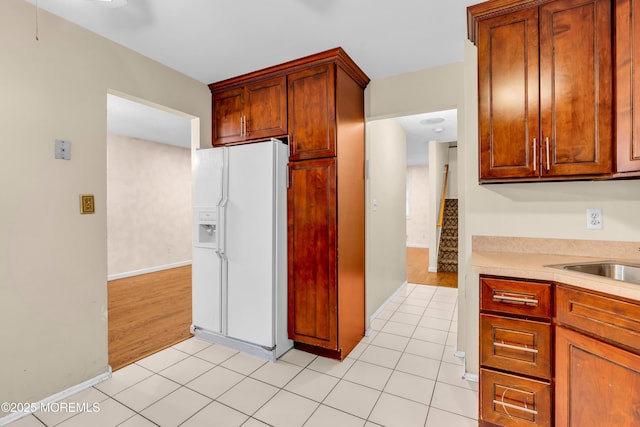 20 Lone Star Ln, Manalapan, NJ 07726 - kitchen featuring white fridge with ice dispenser, light countertops, baseboards, and light tile patterned floors