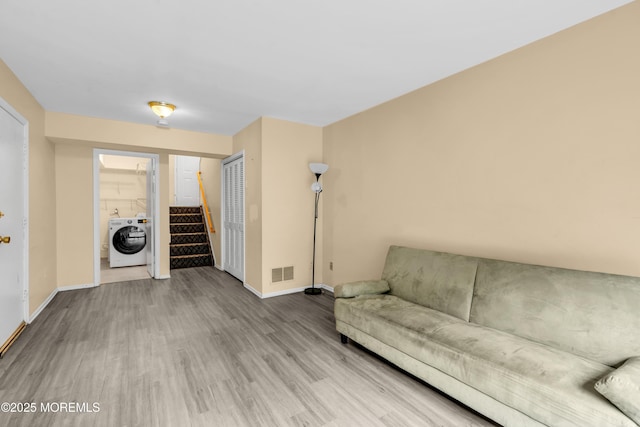 20 Lone Star Ln, Manalapan, NJ 07726 - living room featuring washer / clothes dryer, wood finished floors, baseboards, and stairs