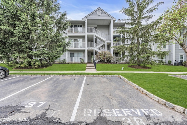69 Rachel Ct, Franklin Twp, NJ 08823 - view of building exterior featuring uncovered parking and stairway