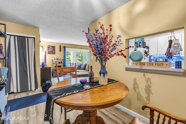69 Rachel Ct, Franklin Twp, NJ 08823 - dining room with wood finished floors, a textured ceiling, and baseboards