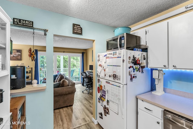 69 Rachel Ct, Franklin Twp, NJ 08823 - kitchen with appliances with stainless steel finishes, a textured ceiling, light wood-style flooring, an office area, and white cabinets