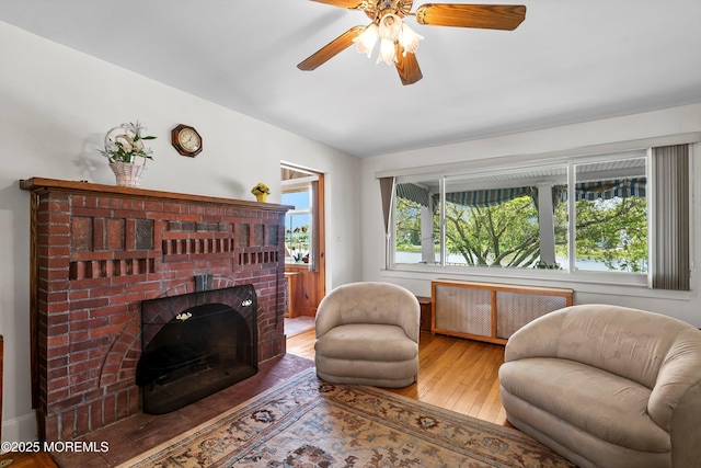 510 Bradley Blvd, Bradley Beach, NJ 07720 - living room featuring radiator, hardwood / wood-style floors, a ceiling fan, and a brick fireplace