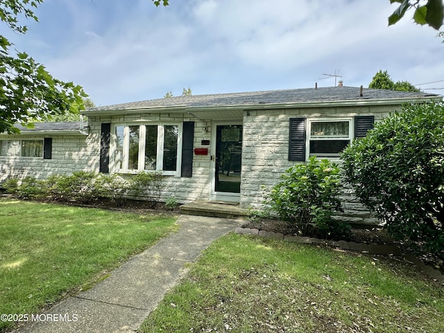 404 Harmony Rd, Middletown, NJ 07748 - view of front of house with a front lawn, stone siding, and roof with shingles