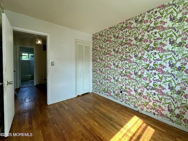 404 Harmony Rd, Middletown, NJ 07748 - spare room with wallpapered walls, hardwood / wood-style floors, baseboards, and a chandelier