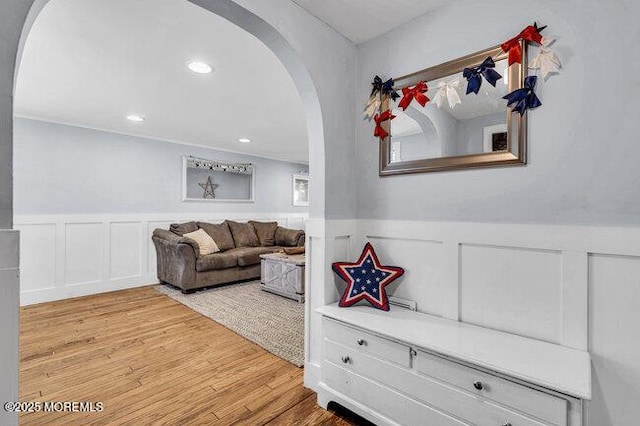2909 Arthur St, Wall, NJ 07719 - living room with arched walkways, wainscoting, wood finished floors, a decorative wall, and recessed lighting