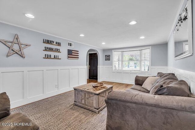 2909 Arthur St, Wall, NJ 07719 - living room with arched walkways, a wainscoted wall, recessed lighting, crown molding, and a decorative wall