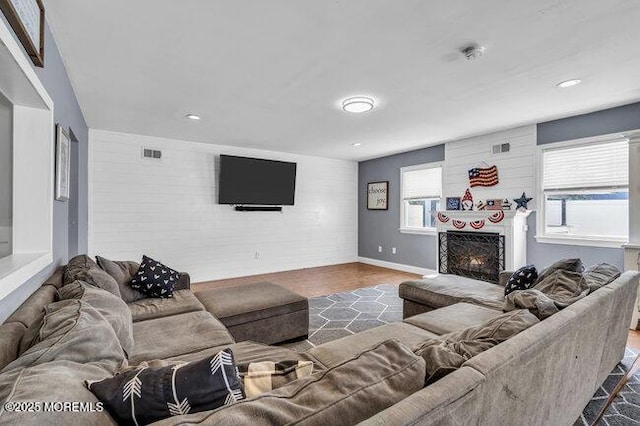 2909 Arthur St, Wall, NJ 07719 - living room featuring a warm lit fireplace, recessed lighting, and wood finished floors