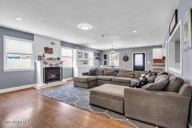 2909 Arthur St, Wall, NJ 07719 - living area featuring hardwood / wood-style flooring, healthy amount of natural light, a lit fireplace, and recessed lighting