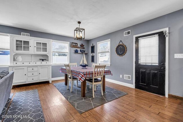 2909 Arthur St, Wall, NJ 07719 - dining space with a chandelier, dark wood finished floors, and healthy amount of natural light