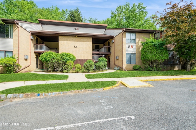 58 Amberly Dr Unit E, Manalapan, NJ 07726 - view of building exterior featuring uncovered parking