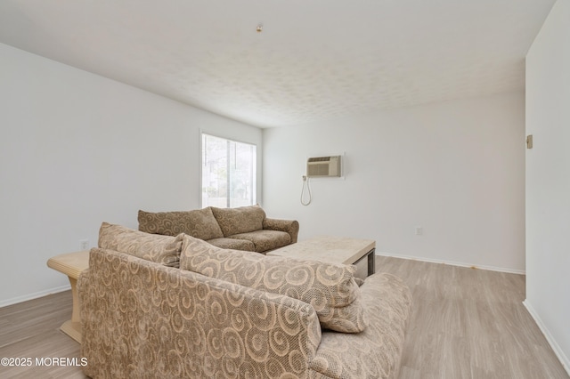 58 Amberly Dr Unit E, Manalapan, NJ 07726 - living area featuring light wood finished floors, a wall mounted AC, and baseboards