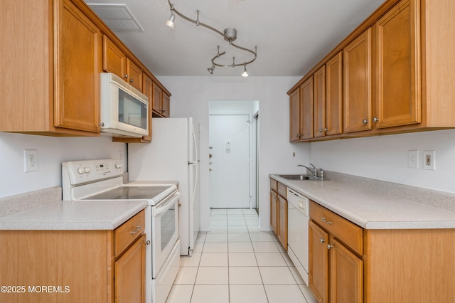 58 Amberly Dr Unit E, Manalapan, NJ 07726 - kitchen featuring white appliances, a sink, light tile patterned floors, light countertops, and brown cabinetry