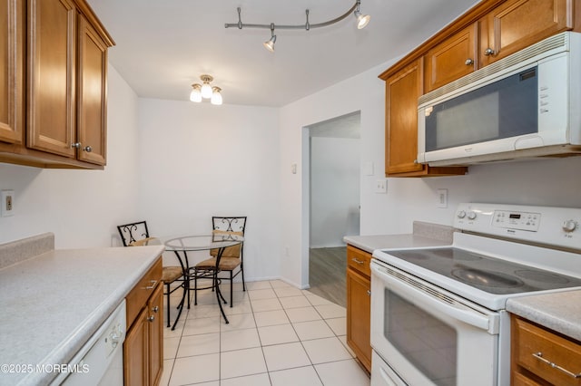 58 Amberly Dr Unit E, Manalapan, NJ 07726 - kitchen with white appliances, brown cabinets, and light countertops