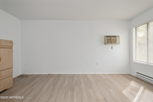 58 Amberly Dr Unit E, Manalapan, NJ 07726 - unfurnished room with a wall mounted AC, light wood-type flooring, a baseboard radiator, and plenty of natural light