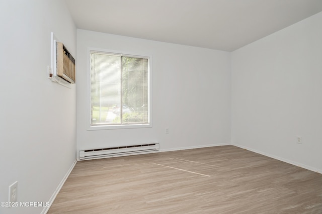 58 Amberly Dr Unit E, Manalapan, NJ 07726 - spare room with a baseboard heating unit, light wood-style floors, a wall mounted air conditioner, and baseboards
