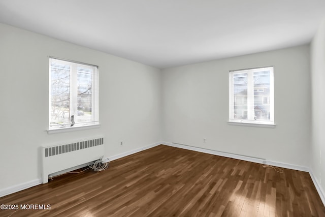 283 Spring St Unit 283B, Red Bank, NJ 07701 - spare room with radiator heating unit, dark wood-style floors, and baseboards