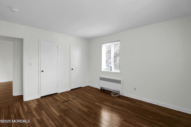 283 Spring St Unit 283B, Red Bank, NJ 07701 - unfurnished bedroom with radiator heating unit, dark wood finished floors, and baseboards