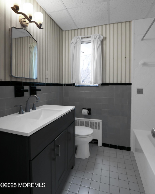 283 Spring St Unit 283B, Red Bank, NJ 07701 - bathroom with tile walls, tile patterned floors, radiator, vanity, and toilet