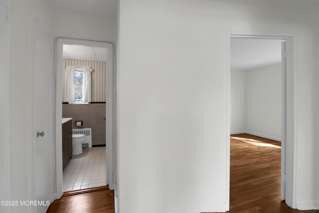 283 Spring St Unit 283B, Red Bank, NJ 07701 - corridor featuring radiator, wood finished floors, and tile walls