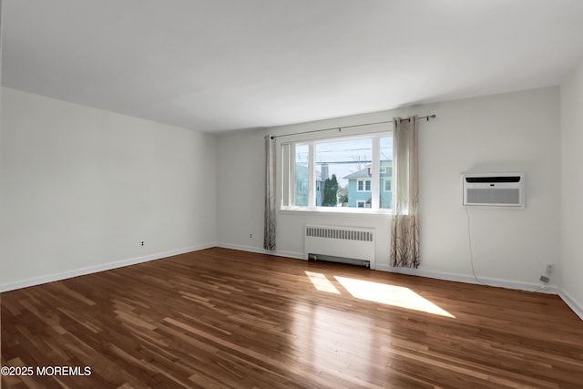 283 Spring St Unit 283B, Red Bank, NJ 07701 - unfurnished living room featuring radiator, an AC wall unit, wood finished floors, and baseboards
