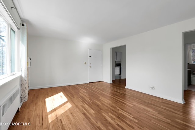 283 Spring St Unit 283B, Red Bank, NJ 07701 - spare room with radiator heating unit, wood finished floors, and baseboards