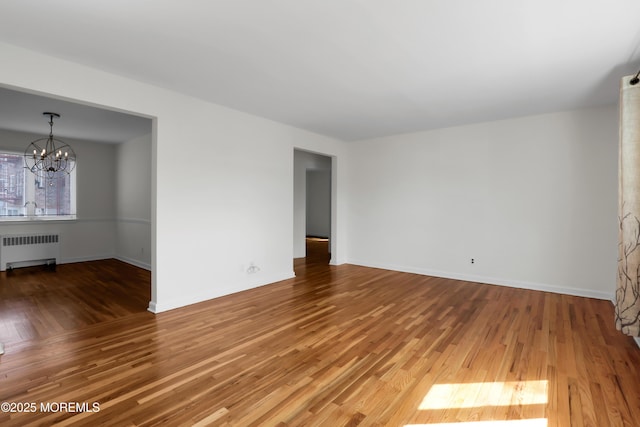 283 Spring St Unit 283B, Red Bank, NJ 07701 - unfurnished room featuring radiator, a chandelier, and wood finished floors