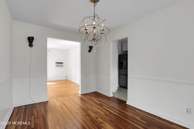 283 Spring St Unit 283B, Red Bank, NJ 07701 - unfurnished dining area featuring a chandelier, wood finished floors, baseboards, and an AC wall unit