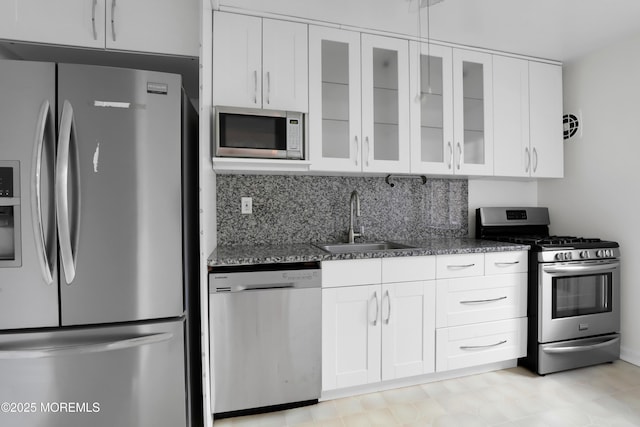283 Spring St Unit 283B, Red Bank, NJ 07701 - kitchen featuring stainless steel appliances, a sink, dark stone counters, white cabinets, and glass insert cabinets