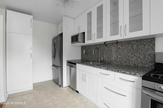 283 Spring St Unit 283B, Red Bank, NJ 07701 - kitchen with appliances with stainless steel finishes, dark stone counters, a sink, and backsplash
