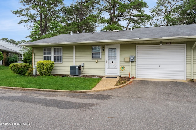 59B Cambridge Cir, Manchester, NJ 08759 - view of front of house featuring central AC unit, asphalt driveway, an attached garage, a front lawn, and a shingled roof