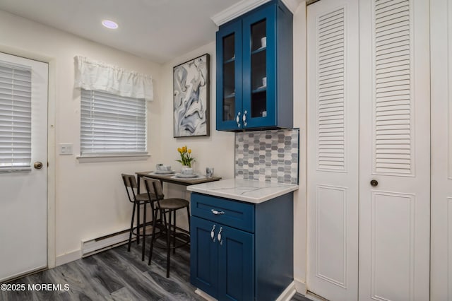 59B Cambridge Cir, Manchester, NJ 08759 - kitchen with blue cabinets, dark wood finished floors, glass insert cabinets, backsplash, and light stone counters