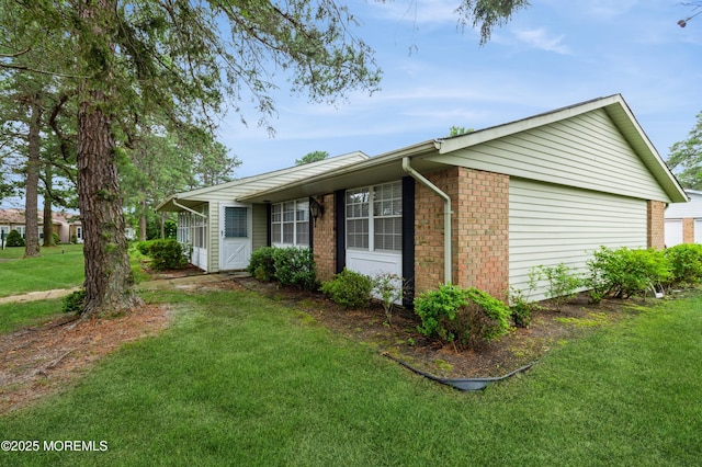 59B Cambridge Cir, Manchester, NJ 08759 - view of side of property with a lawn and brick siding